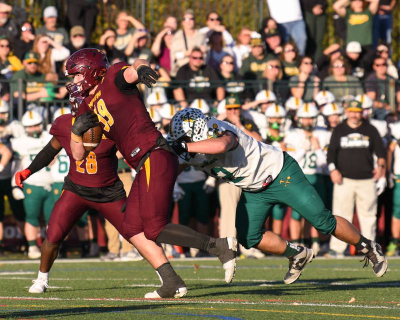 Montini Catholic's Gavin Ericson (59) breaks away from Coal City's Emmett Easton (12) to gains some extra yards before being brought down on Saturday Nov. 15, 2025, during the 4A quarterfinals game held at Montini Catholic High School.