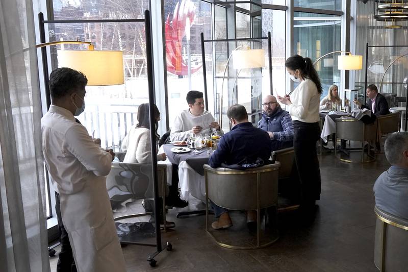 FILE - In this Jan. 27, 2021 file photo, patrons enjoy lunch indoors at Gibsons Italia restaurant in Chicago.    A recent spike in coronavirus cases in some states has led one of the nation's top health experts to suggest that governors could “close things down” like they did during previous surges. But that doesn't appear likely to happen — not even in states led by Democratic governors who favored greater restrictions in the past.  (AP Photo/Charles Rex Arbogast, File)