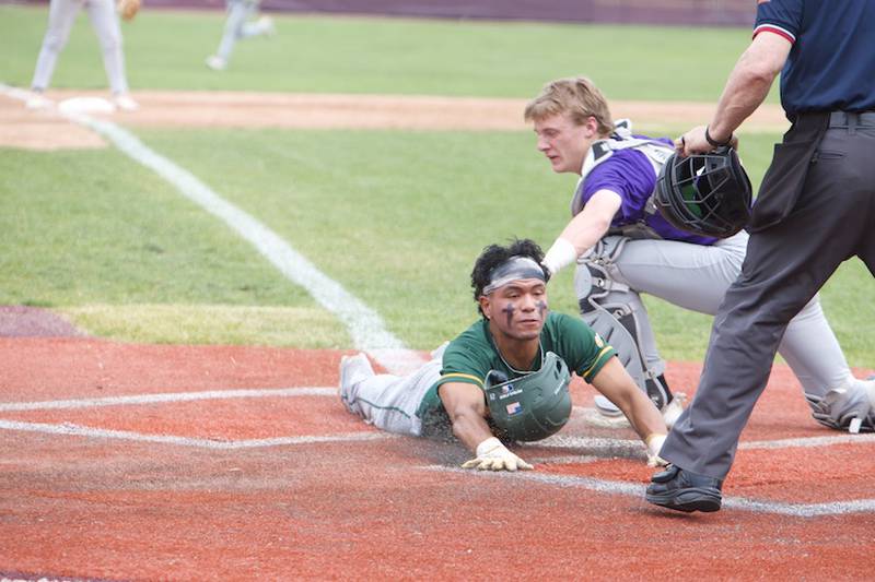 Waubonsie’s Hiroshy Wong slides headfirst into home safely before the tag by Downers Grove North’s Jack Romsey at the Class 4A Sectional Final on Saturday, June 7, 2025 in Lockport.