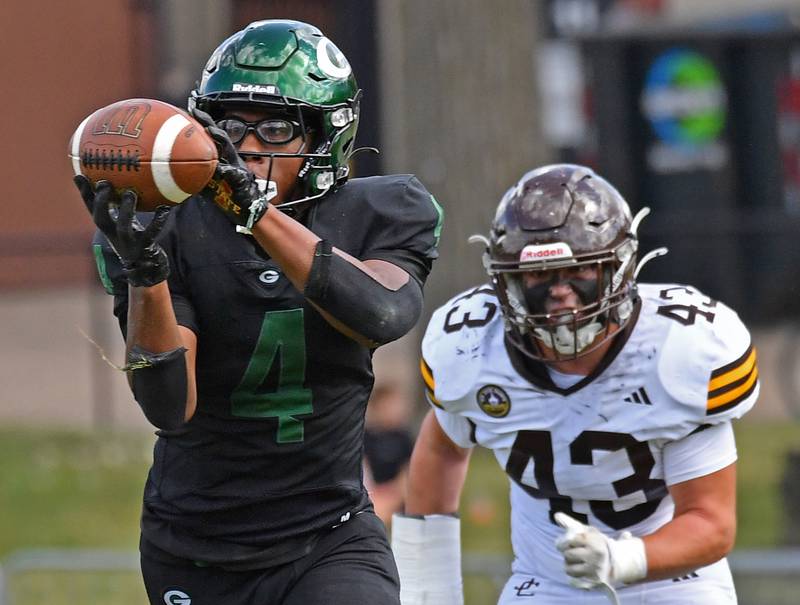 Glenbard West’s Jamarcus Kelly catches a pass in front of Joliet Catholic’s Parker Toole (43) during a game on September 6, 2025 at Glenbard West High School in Glen Ellyn.