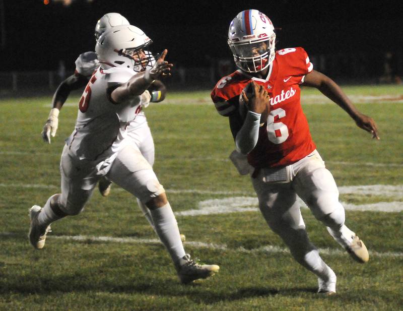 Ottawa quarterback Colby Mortenson (6) runs past the defense of Streator's Cole Winterrowd for a touchdown at King Field on Friday, Sept. 1, 2023.