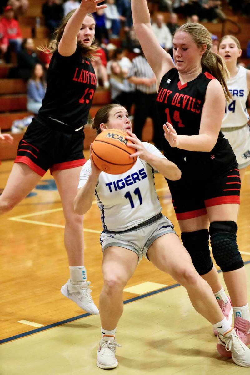 Princeton's Makayla Hecht tries to shoot amongst the trees of Hall defenders Caroline Morris (left) and Ella Sterling in Thursday's game at Prouty Gym. The Tigresses won 34-30.