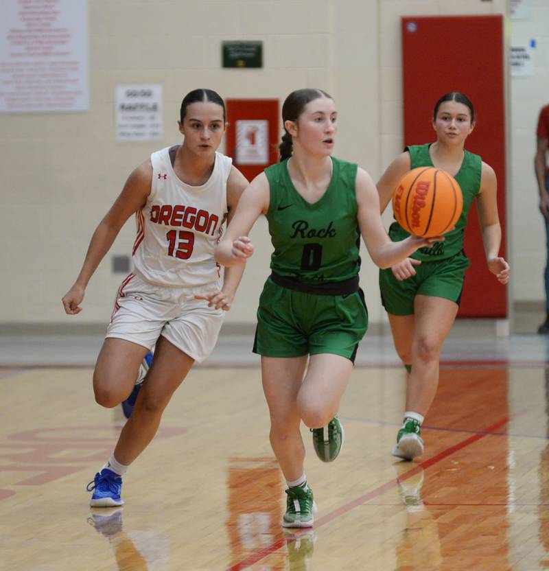 Rock Falls' Miley Bickett (0) dribbles up the court as Oregon's Sarah Eckardt (13) gives chase during 2A regional action on Saturday, Feb. 15, 2025 at Oregon High School.