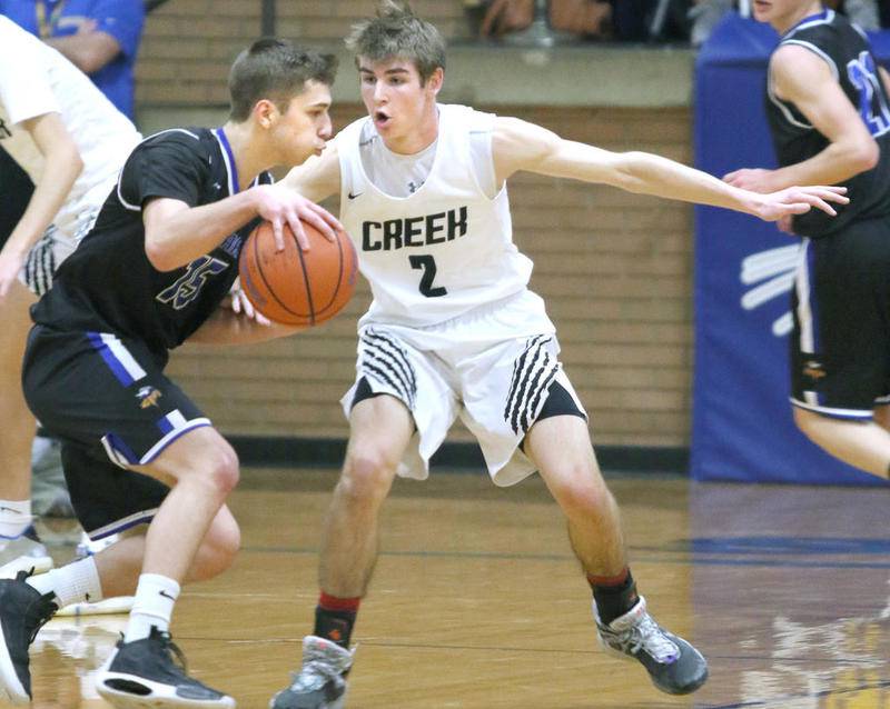 Indian Creek junior Cameron Russell plays tight defense against Newark senior Nathan Christian during their Little 10 conference championship game Friday at Somonauk High School.