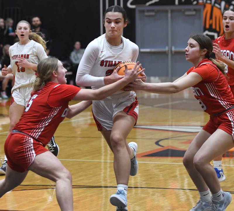 Stillman Valley's Emma Withers (21) drives to the basket as Oregon's Shaylee Davis (left) and Lola Schwarz (right) defend at the 2A Winnebago Regional on Monday, Feb. 16, 2026 at Winnebago High School.