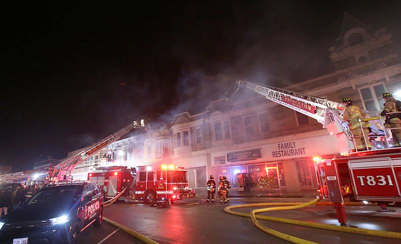 Firetrucks line the entire block of Indiana Avenue as firefighters extinguish flames from a second story apartment at 708 Illinois Avenue on Friday, Dec. 30, 2022 downtown Mendota.