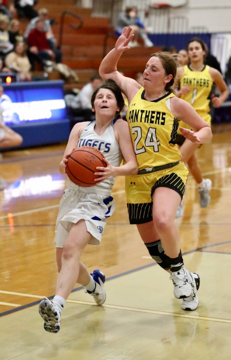 Princeton's Camryn Driscoll tries to get past Putnam County's Gracie Cuicci for a shot in tournament play at Princeton Monday. The Tigresses won 62-36.