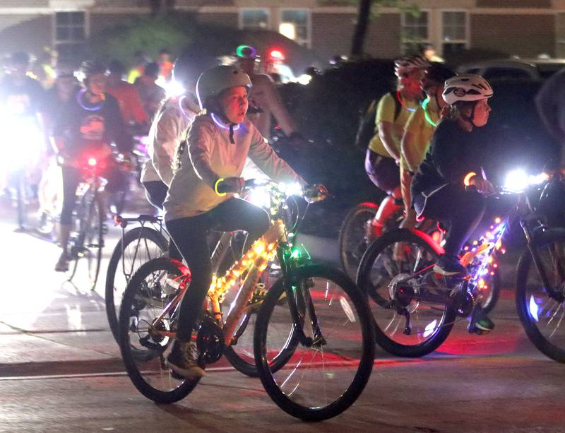 Participants begin the Raue Center for the Arts Night Owl Bike Ride in Crystal Lake on Saturday, August 2, 2025.