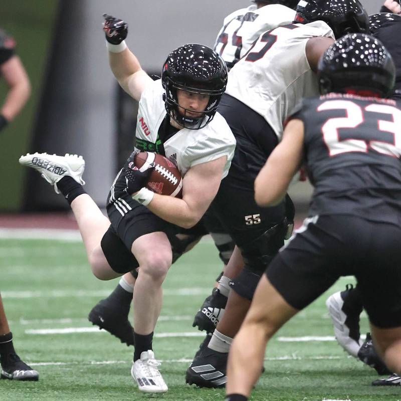 Northern Illinois University running back Justin Lynch carries the ball Tuesday, March 26, 2024, during spring practice in the Chessick Practice Center at NIU.