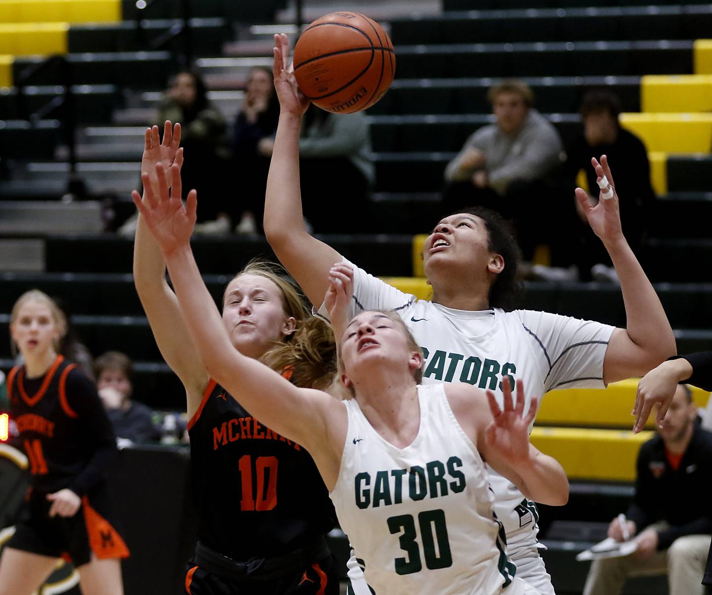 Crystal Lake South's Nicole Molagdo grabs a rebound over McHenry's Bethany Snyder  and her teammate. Hanna Massie, during a Fox Valley Conference girls basketball game Tuesday Jan. 10, 2023, at Crystal Lake South High School.