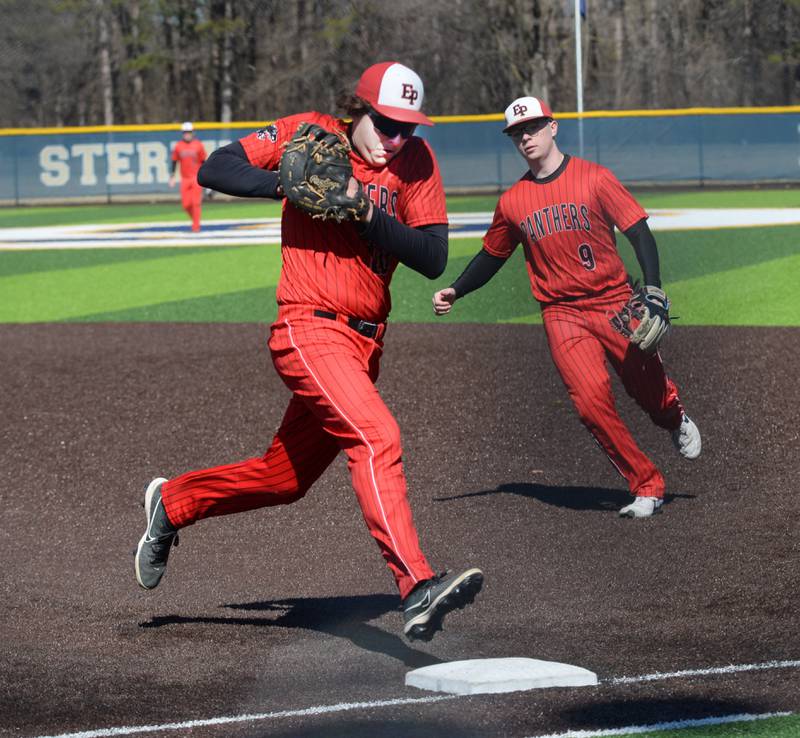 Erie-Prophetstown's Eli Heyvaert steps on first for the out as Braylon Swertzfeger backs up the play against Sterling on Saturday, March 22, 2025 game at Gartner Park in Sterling.