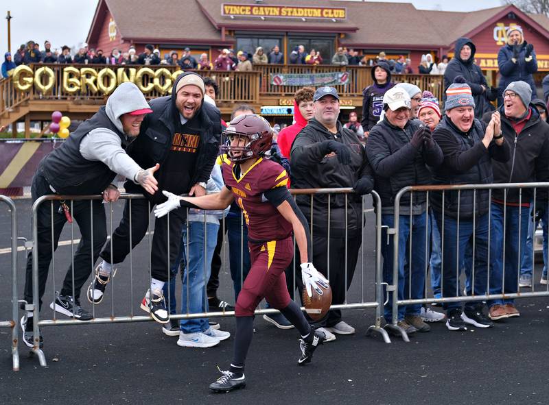 Montini's Santino Florio completes sharing high fives with a row of fans after scoring a touchdown during a Class 3A semifinal game on November 23, 2024 at Montini Catholic High School in Lombard.