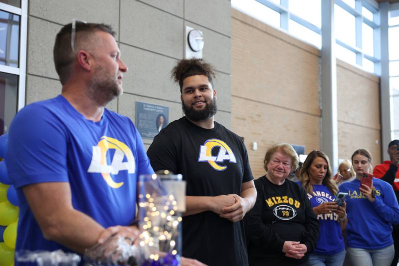 Keagen Trost, a 2019 Kankakee High School grad, listens as Athletic Director Ronnie WIlcox commends Trost for his hard work and accomplishments during a celebration held for him at the school on May 4, 2026, following him being drafted into the NFL to the Los Angeles Rams.