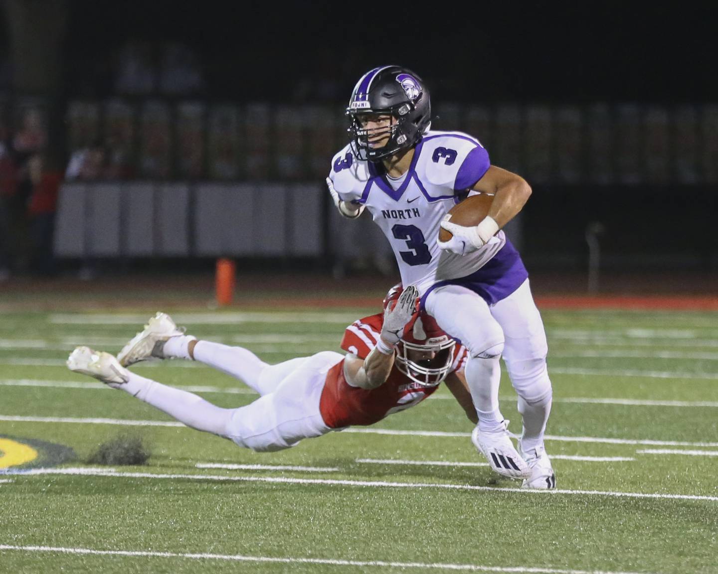 Downers Grove North's Ethan Thulin (3) runs back a punt during football game between Downers Grove North at Hinsdale Central. Oct 1, 2021.