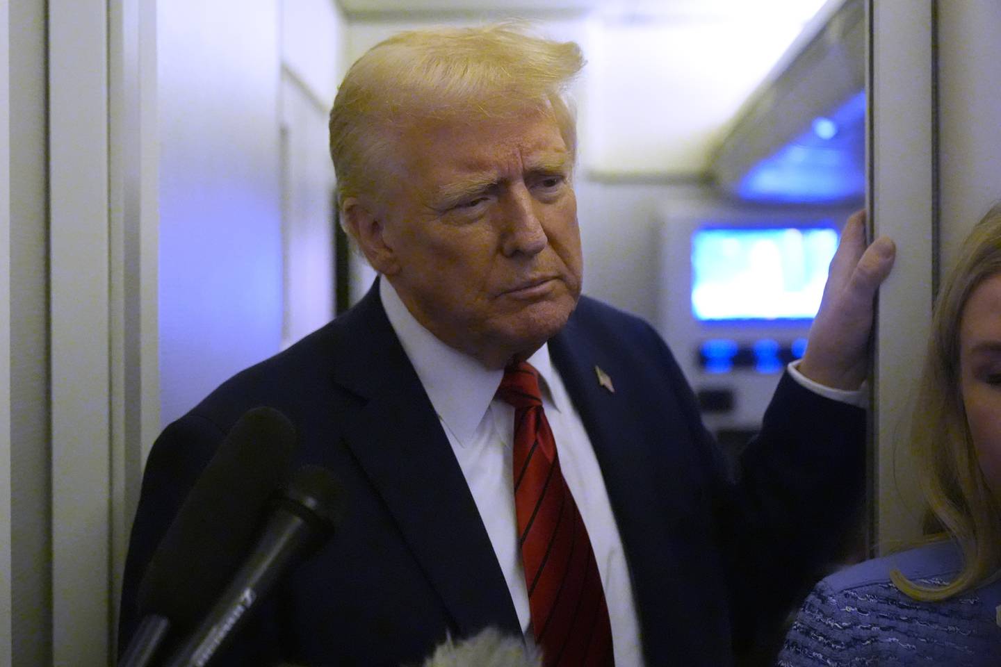 President Donald Trump speaks to reporters aboard Air Force One en route from Miami to Joint Base Andrews, Md., Monday, Jan. 27, 2025. (AP Photo/Mark Schiefelbein)