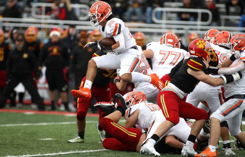 Hersey’s Charles Meister gets some air over Batavia’s defense during their Class 7A second-round playoff game in Batavia on Saturday, Nov. 5, 2022.