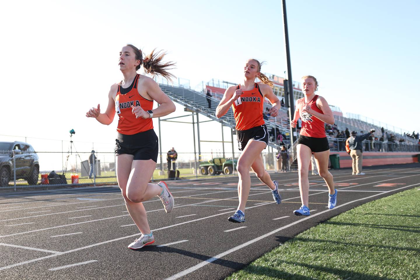 Minooka’s Jocelyn Host, left, Gabriella McCollom followed by Lincoln-Way West’s Claire Carter head up the pack in the 3200 meter run at the Minooka track invitational. Thursday, April 14, 2022, in Minooka.