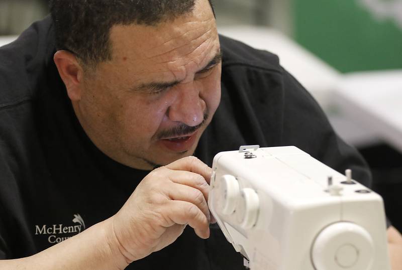 Eloy Rodriquez, of McHenry County College, tries to repeal a sewing machine during a Repair Fair on Tuesday, April 15, 2025, at McHenry County College.