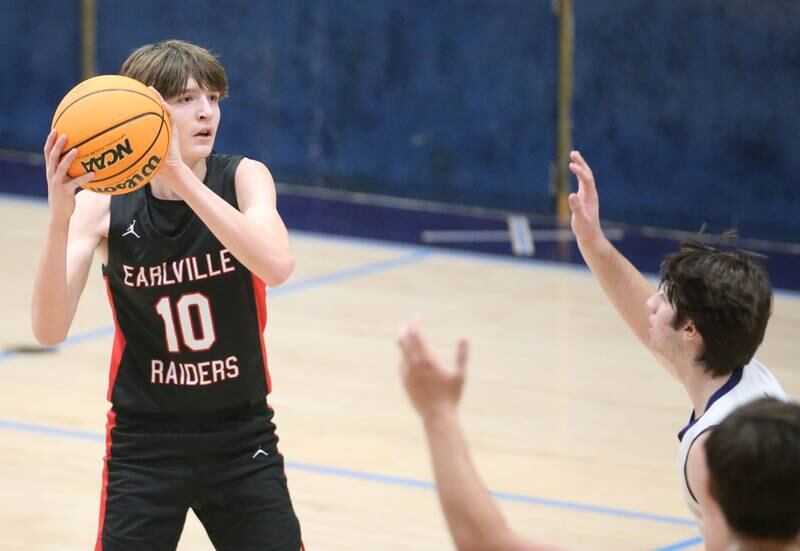 Earlville's Easton Fruit eyes the hoop while looking to pass as Marquette's Alec Novotney defends on Friday, Jan. 3, 2025 in Bader Gym at Marquette High School.