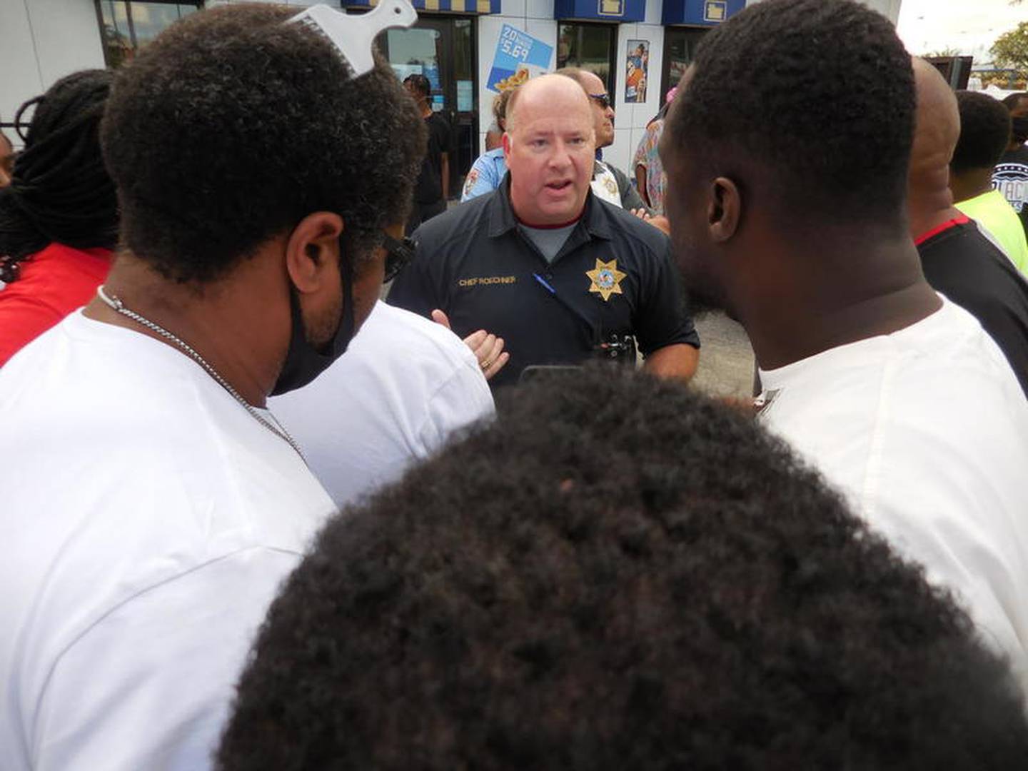 Joliet Police Chief Al Roechner engaged with demonstrators at a rally Sunday to protest the death of Eric Lurry.