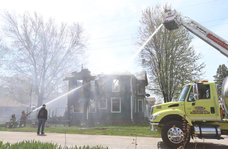 Firefighters from Paw Paw, Somonauk, Troy Grove, Mendota, Earlville, Leland, Utica and Ottawa work the scene of a house fire in the 300 block of Maple Street on Monday, April 22, 2024 in Earlville. The fire happened around 10a.m.
