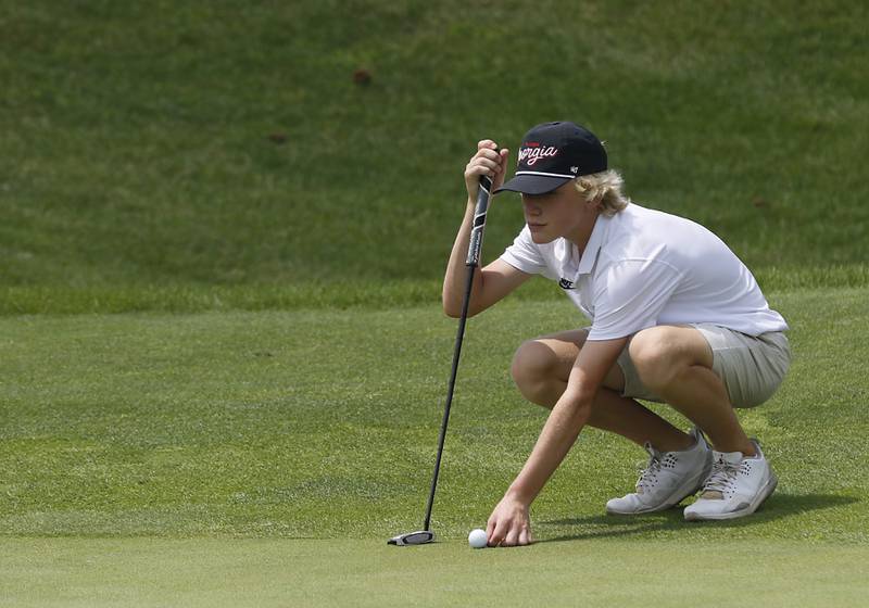 Samuel Sterzik lines up his putt on the fourth green during the final round of McHenry County Junior Amateur Golf Tournament  on Tuesday, July 18, 2025, at Foxford Hills Golf Club in Cary.