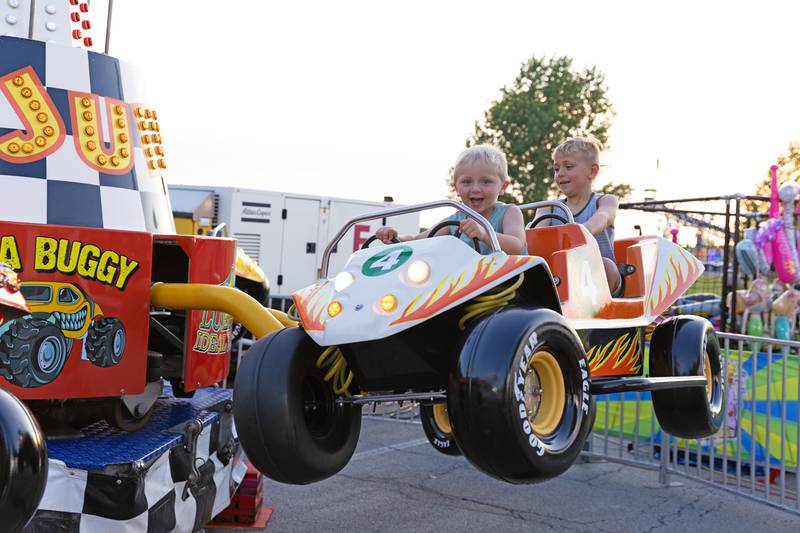 Brothers Caiden, 3, and Noah Pedersen, 6, enjoy a thrilling ride during the 50th Bourbonnais Friendship Festival on Thursday, June 26, 2025.