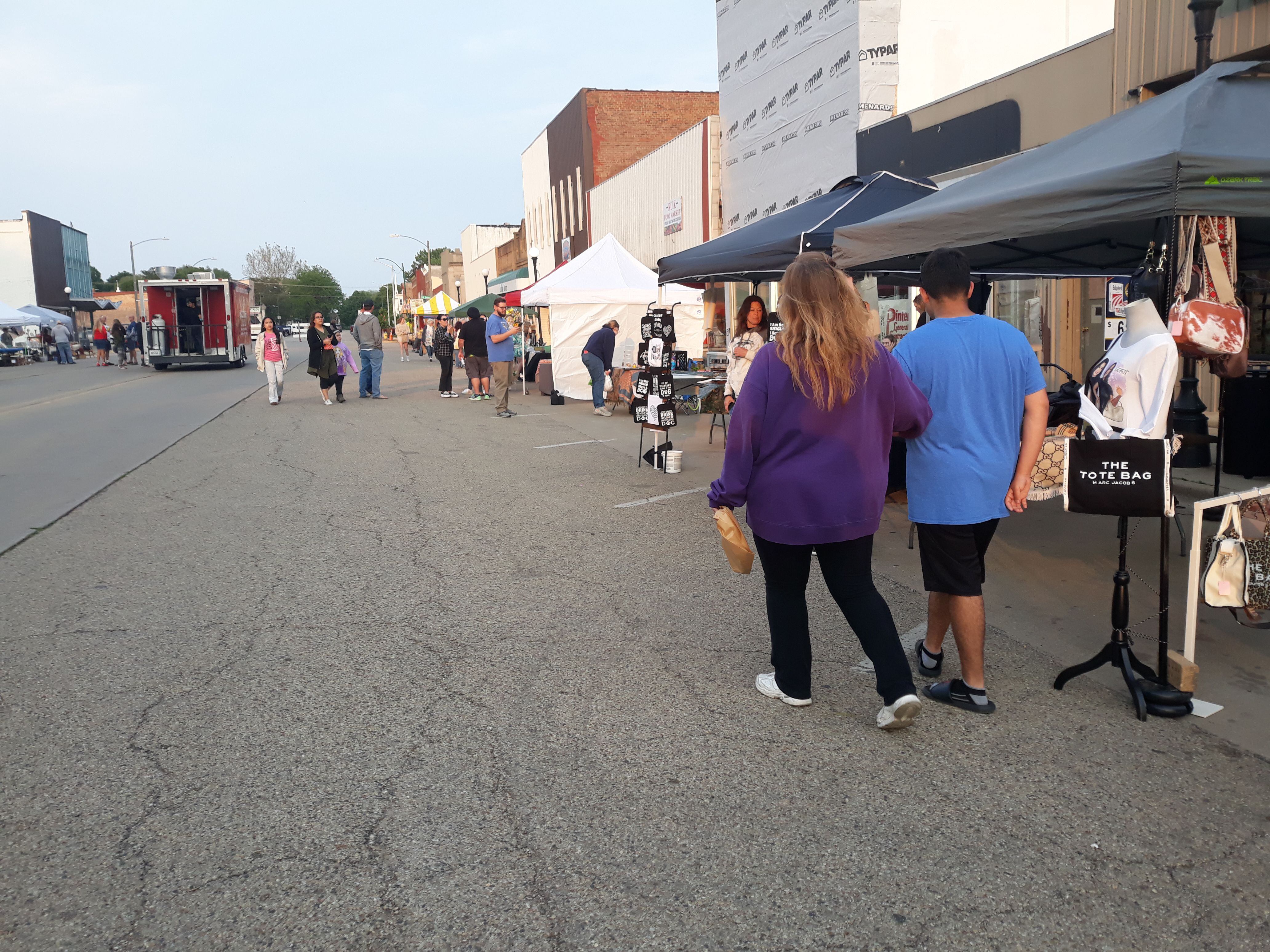 Visitors at GROW Spring Valley's first Friday Night Market peruse the 40 artisan vendors Friday, May 19, 2023, along St. Paul Street.