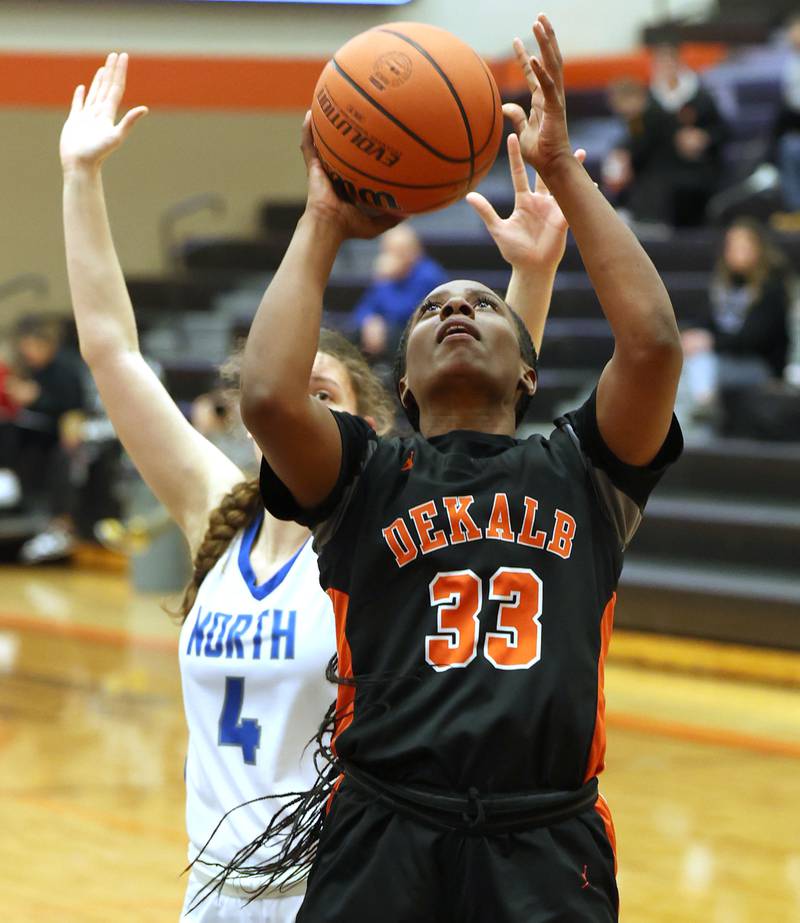 DeKalb’s Cayla Evans gets up a shot in front of Wheaton North's Elsa Carlson during their Class 4A regional game Monday, Feb 12, 2024, at DeKalb High School.