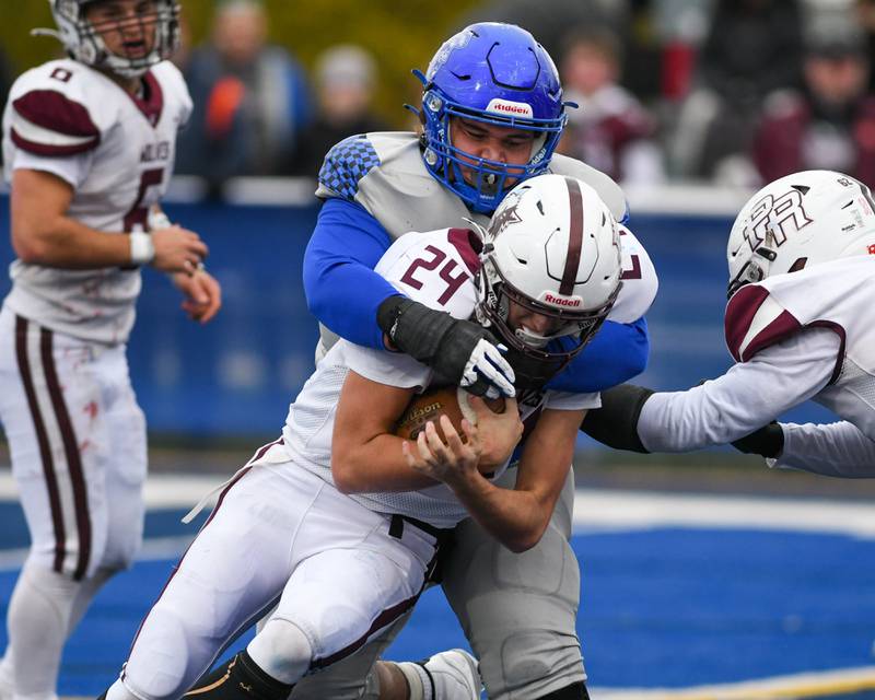 St. Francis's Jaylen Torres (54) brings down Prairie Ridge's Vincent Byk (24) before gaining extra yards on Saturday Nov. 8, 2025, during the second round of the 5A playoff game held at St. Francis's High School.