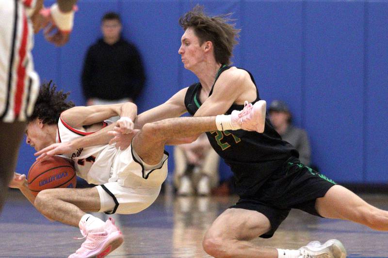 Huntley’s Lucas Crosby, left, tussles with Crystal Lake South’s James Carlson in varsity basketball tournament title game action at Johnsburg Friday.