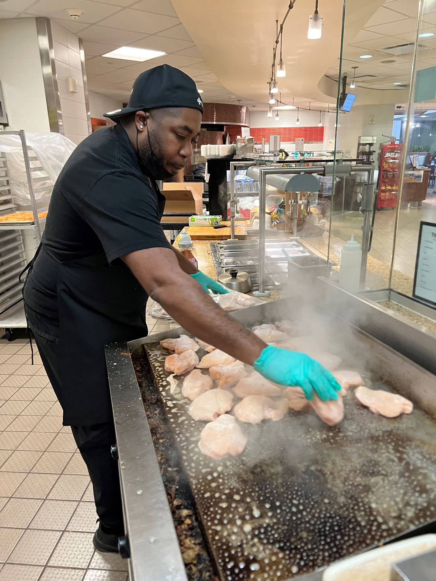 George Funches of Crest Hill is seen working in the Silver Cross Hospital Cafeteria. Funches developed a pork tenderloin sandwich that’s become a popular menu item in the cafeteria. The sandwich consists of a deep-fried pork tenderloin, spicy mayonnaise, grilled onions, American cheese and warmed-up sesame seed bun.