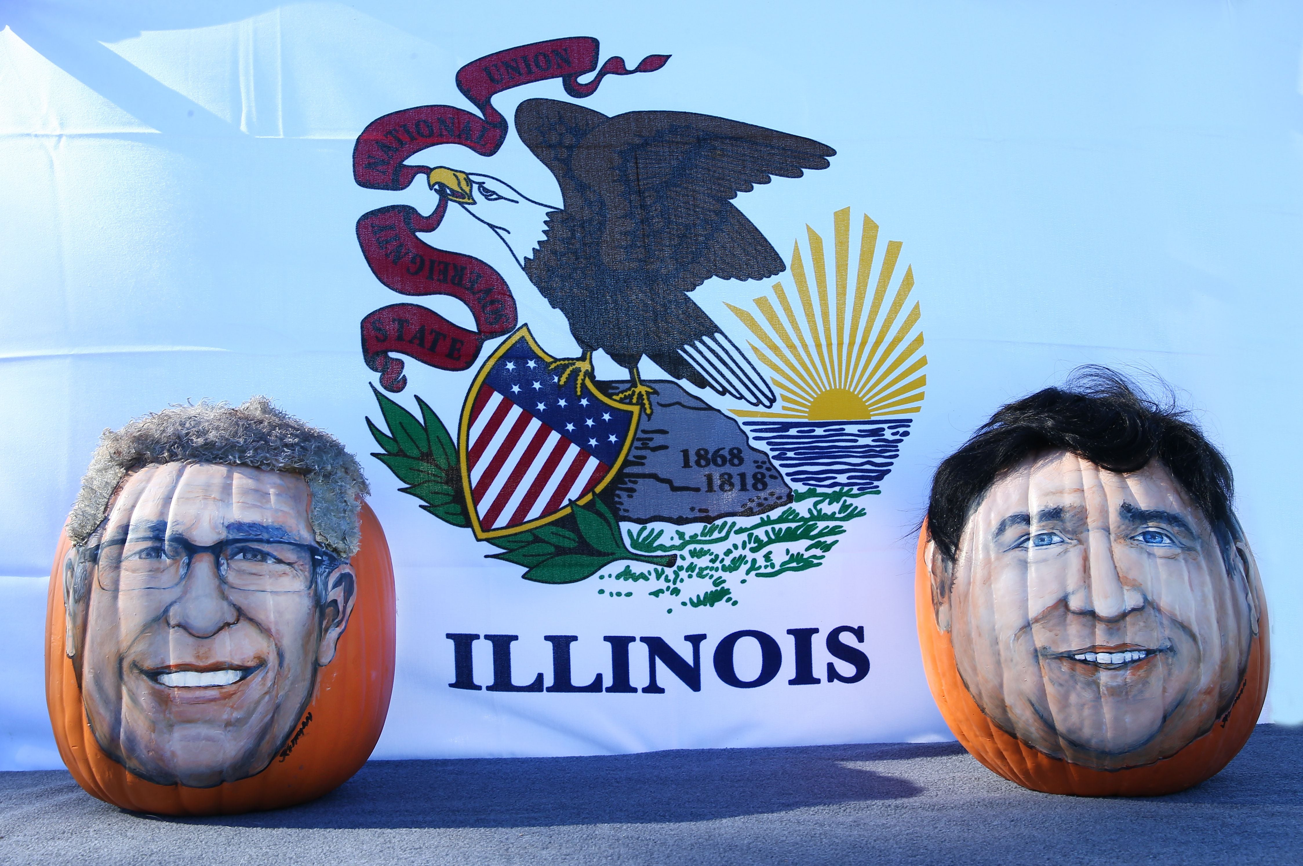 Pop artist John Kettman, of La Salle, replicated Gov. JB Pritzker and Republican candidate Darren Bailey on pumpkins, showing them off Wednesday, Sept. 28, 2022, at Allen Park in Ottawa.
