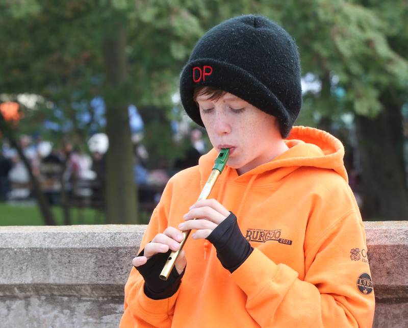 Dane Passwater of Ottawa, playes a Irish tin whistle over the Illinois Michigan canal bridge on Mill Street during the 53rd annual Burgoo on Sunday, Oct. 8, 2023 downtown Utica.