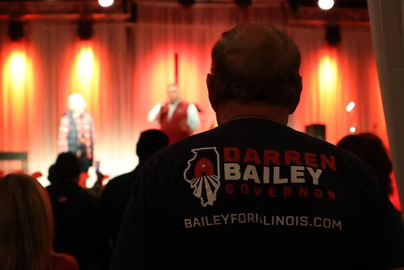 A supporter listens to Republican Governor candidate Darren Bailey speak at the GOP rally at 115 Bourbon Street in Merrionette Park on Monday.
