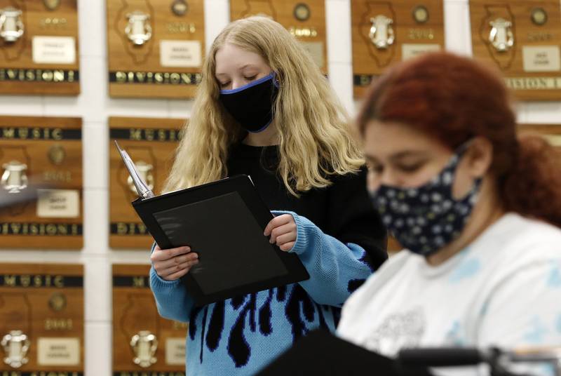 Students Corinne Sieff, back, and Kimmy Velez rehearse the school song for a graduation performance in choir class with teacher Brian Jozwiak at Woodstock High School on Wednesday, May 12, 2021 in Woodstock.