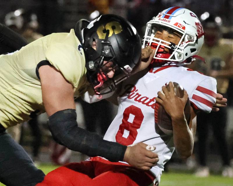 Sycamore's Kyle Prebil lays a big hit on Ottawa's Bryson Valdez during their game Friday, Sept. 27, 2024, at Sycamore High School.