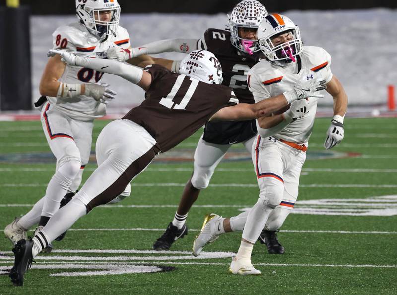 Oswego's Teddy Manikas tries to get by Mount Carmel's Cullen Winters Wednesday, Dec. 3, 2025, during their IHSA Class 8A state chamionship game in Huskie Stadium at Northern Illinois University in DeKalb.