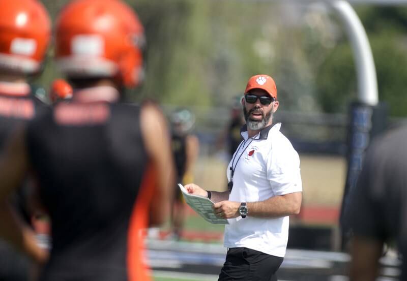Wheaton Warrenville South Head Coach Sean Norris talks to his players during a 7-on-7 football game against Hersey at St. Charles North on Thursday, June 22, 2023.