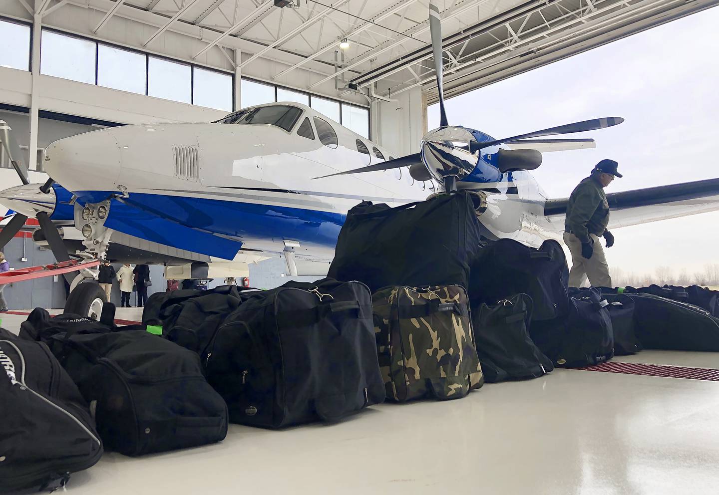 Approximately 50 bags of supplies that include toiletries, combat gear that includes tourniquets, medical supplies and crutches are lined up and will be packed a plane's fuselage and will then be flown to John F. Kennedy International Airport in New York City then on to Poland for the Ukrainian refugees.