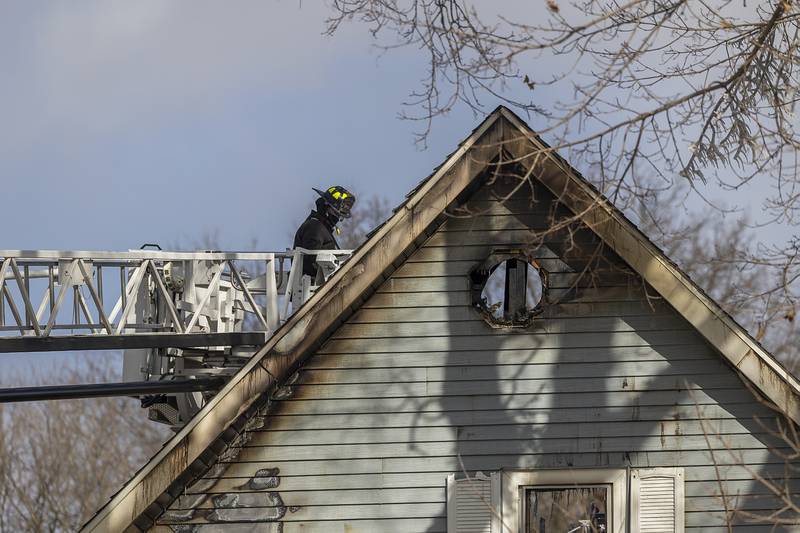 Firefighters continue their search Monday, Jan. 20, 2025, of a possible victim of a house fire in rural Sterling.