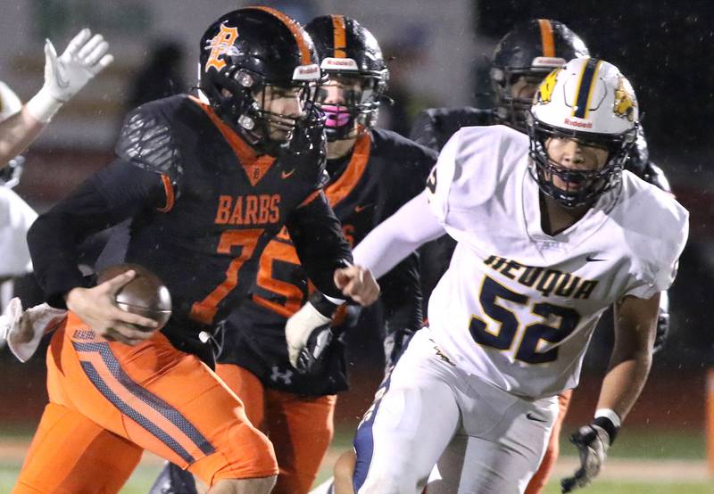 Neuqua Valley's Adam Filburn tries to stop DeKalb's Adrien McVicar as he scrambles out of the pocket during their game Friday, Oct.14, 2022, at DeKalb High School.