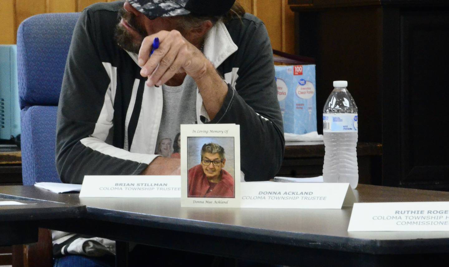 A memorial card sits next to former Township Trustee Donna Ackland's seat at the boards meeting May 13, 2026. Ackland died and the township is looking to appoint a trustee to serve the remainder of her term.