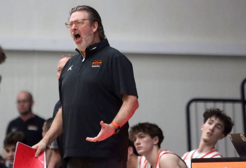 McHenry’s Head Coach Corky Card guides the Warriors against Cary-Grove in varsity boys basketball on Tuesday, Feb. 17, 2026, at McHenry High School in McHenry.