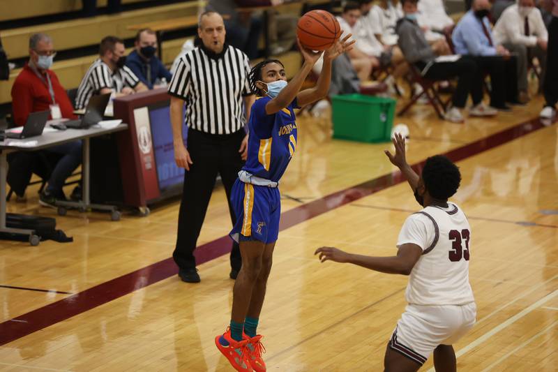 Joliet Central’s Timarion Sanders puts up a three point shot against Lockport. Monday, Jan. 31, 2022 in Lockport.