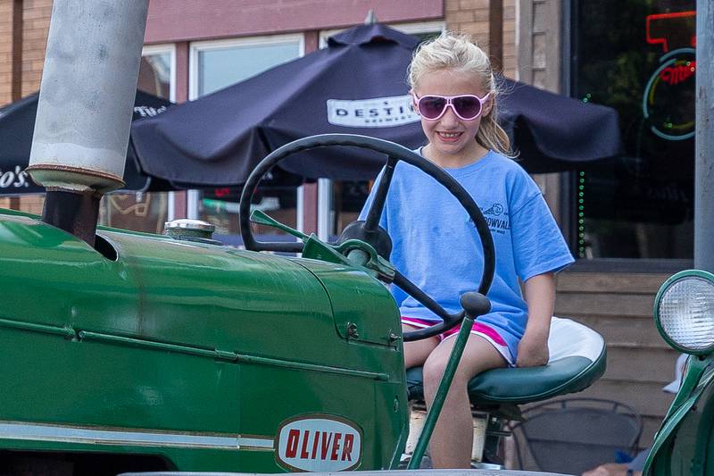 Elaina Close sits on a tractor at the 20th annual Cruise Night on Friday, August 8, 2025, on Main Street in Marseilles.
