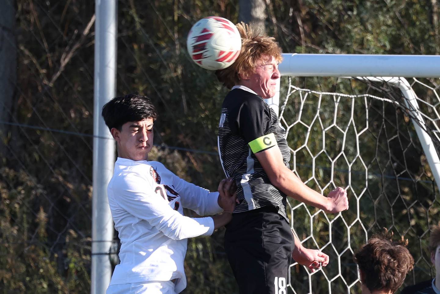 Kaneland's Matthew Mitchinson heads the ball in front of DeKalb's Joaquin Medina-Benitez during their game Thursday, Oct. 17, 2024, at Kaneland High School in Maple Park.