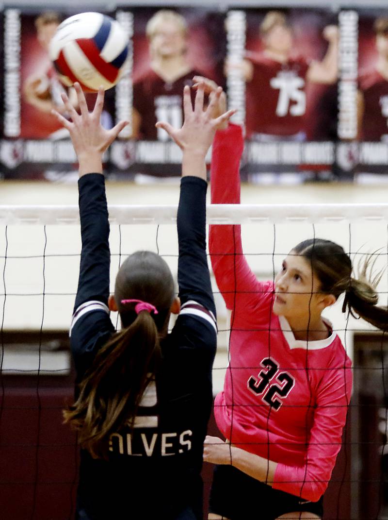 Huntley's Izzy Whitehouse (right) hits the ball past the block of Prairie Ridge's Addison Smith during a Fox Valley Conference volleyball match on Tuesday, Oct. 14, 2025, at the Prairie Ridge High School in Crystal Lake.