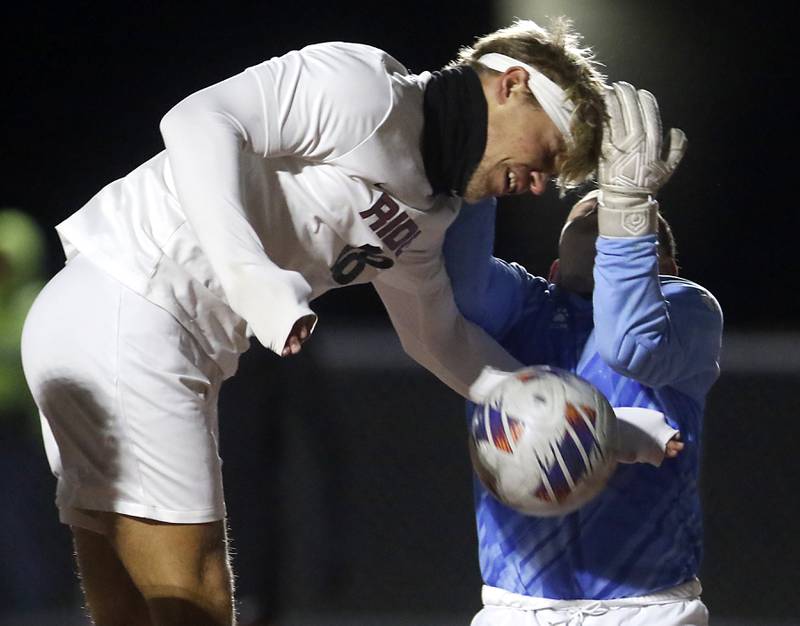 Prairie Ridge's Gabriel Porter tries to head the ball into the goal as McHenry's Mason Bertone tries to grab the ball during a Fox Valley Conference soccer match on Tuesday, Oct. 15, 2024, at McCraken Field in McHenry.