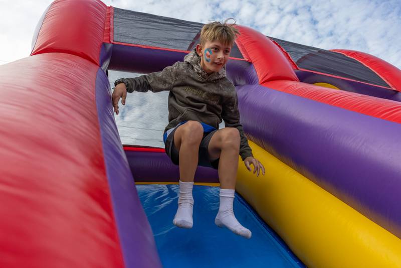 Jase Keegan jumps down the inflatable slide while waiting for the Randy Houser concert to begin at the Marshall Putnam Fair on June 17, 2025 in Henry Illinois.